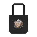 A black canvas tote bag with a graphic of an octopus sitting in a delicate victorian teacup. looks very  cottage friendly for lovers of kitchen magic and cozy looks