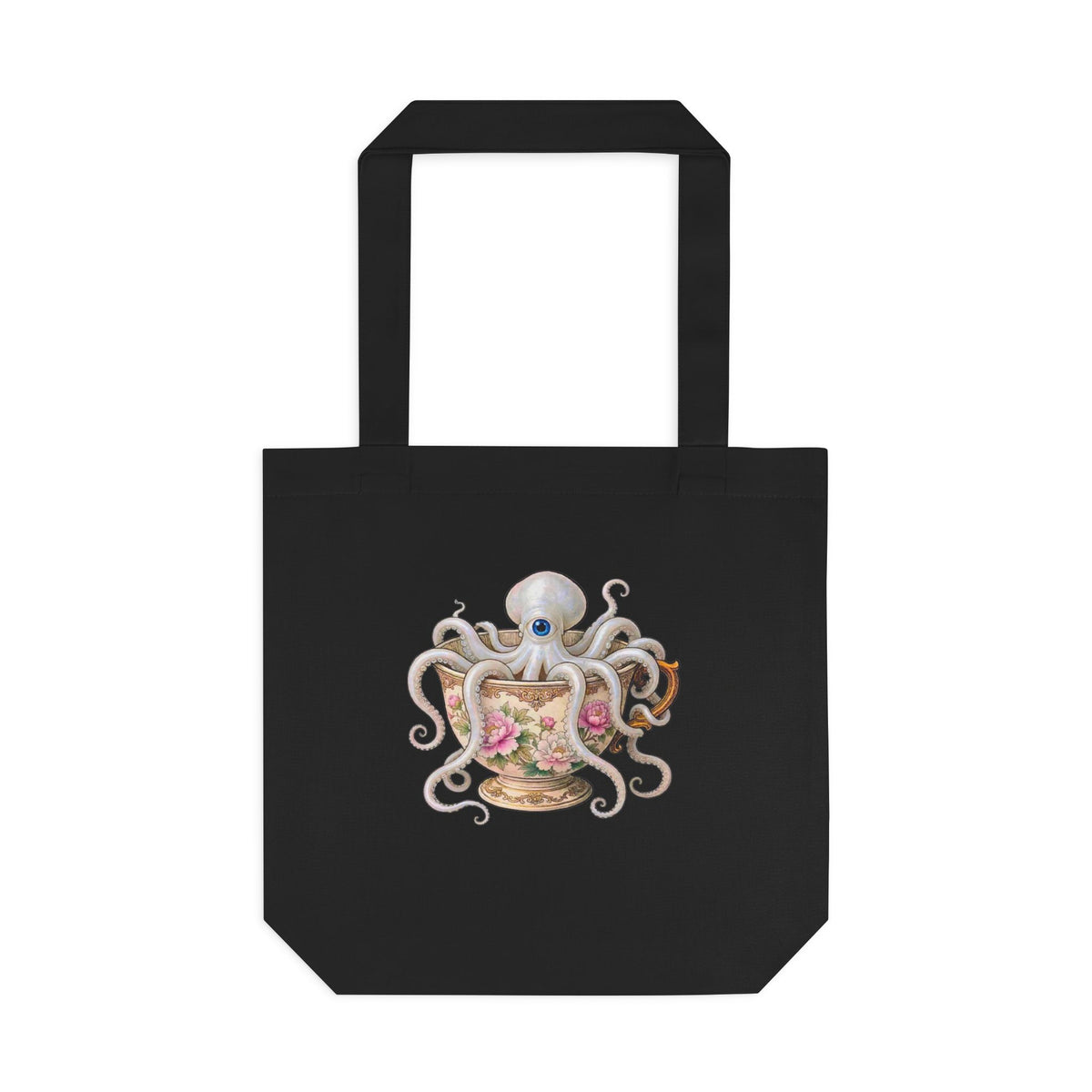 A black canvas tote bag with a graphic of an octopus sitting in a delicate victorian teacup. looks very  cottage friendly for lovers of kitchen magic and cozy looks