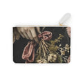 A rectangular zip pouch with a printed vintage-style floral and hand motif in muted pink, beige, and black tones, featuring a white zipper pull and gold zipper trim, shown on a plain white background. this image fits a goth style, it also fits dark cottage vibes