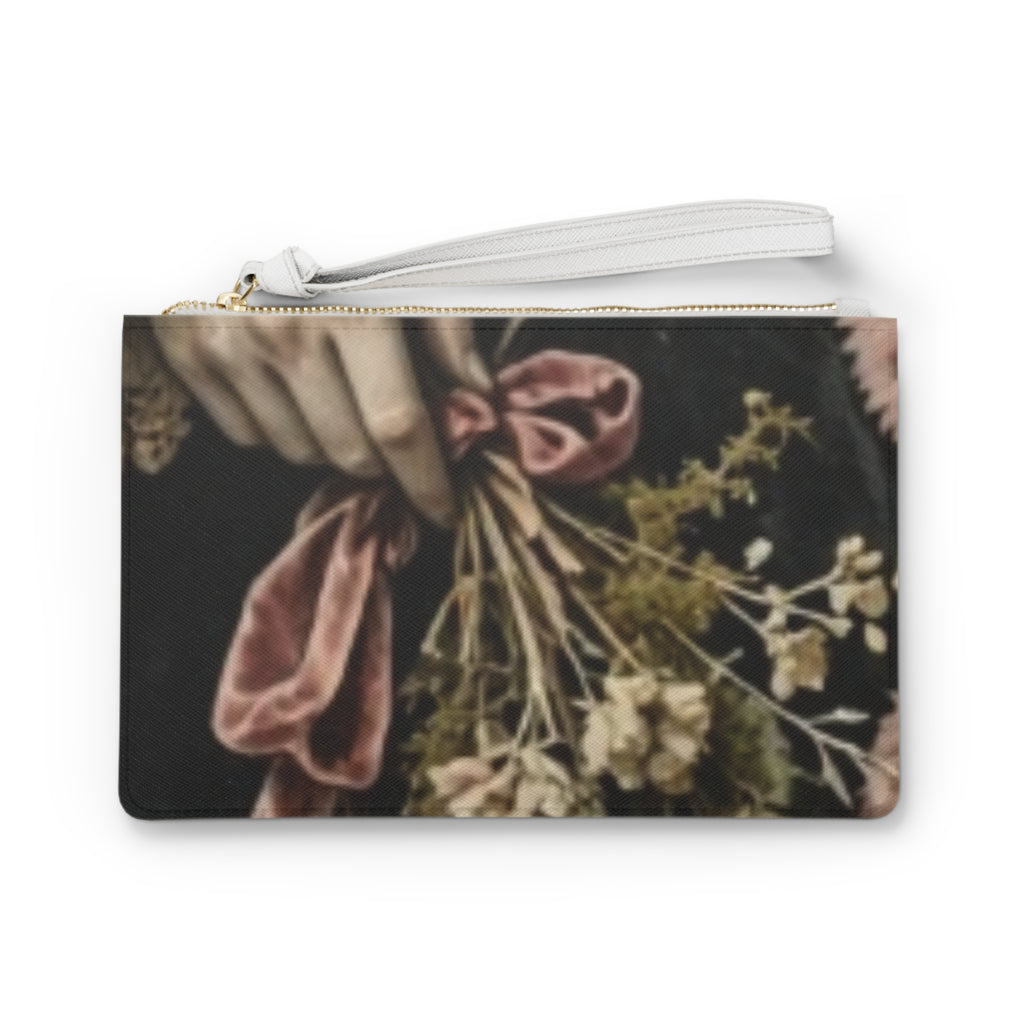 A rectangular zip pouch with a wrist strap, featuring a vintage-style floral print with a hand holding a bouquet of dried flowers and a dusty pink ribbon against a dark background. this image is victorian style. it looks goth and also looks dark cottage style