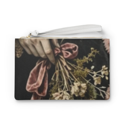 A rectangular zip pouch with a wrist strap, featuring a vintage-style floral print with a hand holding a bouquet of dried flowers and a dusty pink ribbon against a dark background. this image is victorian style. it looks goth and also looks dark cottage style